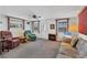 Cozy living room with large windows and an electric fireplace insert at 1212 41St Avenue E Dr, Ellenton, FL 34222