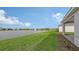 Beautiful backyard view featuring a serene lake with a fountain and well-maintained landscaping at 12520 Brookgreen St, Venice, FL 34293