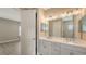 Light and bright bathroom with double vanity, nice mirrors and lighting at 12520 Brookgreen St, Venice, FL 34293