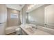 Bathroom featuring a shower over tub, a large mirror and a single sink vanity at 12520 Brookgreen St, Venice, FL 34293
