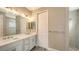 Modern bathroom featuring dual sinks, spacious shower, and vanity lighting at 12520 Brookgreen St, Venice, FL 34293
