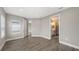 Spacious bedroom with wood-look tile flooring and view to bathroom at 12520 Brookgreen St, Venice, FL 34293