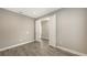 Bedroom featuring gray walls, wood-look flooring, and double doors at 12520 Brookgreen St, Venice, FL 34293