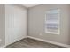 Small bedroom offers wood-look tile flooring, closet and window at 12520 Brookgreen St, Venice, FL 34293