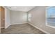 Well lit bedroom with wood look tile flooring and several windows for natural lighting at 12520 Brookgreen St, Venice, FL 34293