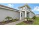 Home exterior featuring manicured landscaping, blue door, and tile roof at 12520 Brookgreen St, Venice, FL 34293