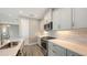 Modern kitchen featuring white cabinets, subway tile backsplash, and stainless steel appliances at 12520 Brookgreen St, Venice, FL 34293