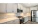 Close up of new kitchen featuring white cabinets, subway tile backsplash, and stainless steel appliances at 12520 Brookgreen St, Venice, FL 34293