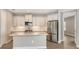 Modern kitchen with white cabinets, stainless steel appliances, and gray tile flooring at 12520 Brookgreen St, Venice, FL 34293