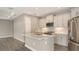 Bright kitchen featuring white cabinets, stainless appliances, a center island, and recessed lighting at 12520 Brookgreen St, Venice, FL 34293