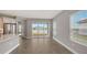 Open concept kitchen and living room with wood-look tile flooring and sliding glass doors to outdoor patio at 12520 Brookgreen St, Venice, FL 34293