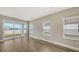 Bright living room featuring wood-look tile floors, and sliding glass doors to an outdoor patio with water view at 12520 Brookgreen St, Venice, FL 34293