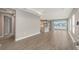 Open concept living room with wood-look tile flooring, neutral walls, and natural light at 12520 Brookgreen St, Venice, FL 34293