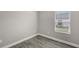 Empty room showcasing hardwood flooring and a window bringing in natural light at 12520 Brookgreen St, Venice, FL 34293