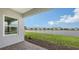 Outdoor patio with a view of a tranquil lake and community homes at 12520 Brookgreen St, Venice, FL 34293