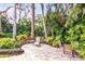 Serene backyard with a brick patio, lush landscaping, and comfortable lounge seating at 1538 S Orange Ave, Sarasota, FL 34239