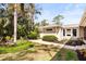 Beautiful backyard with mature trees, lush landscaping, and outdoor seating area for relaxation and entertainment at 1538 S Orange Ave, Sarasota, FL 34239