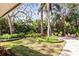Serene backyard with lush landscaping, manicured lawn, and paved patio area for outdoor enjoyment at 1538 S Orange Ave, Sarasota, FL 34239
