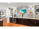 Stylish bar area with custom cabinetry, a wine cooler, and a view into the living room at 1538 S Orange Ave, Sarasota, FL 34239