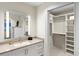 Bright bathroom with stone counters, white cabinets, and a closet at 1538 S Orange Ave, Sarasota, FL 34239