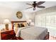 Bedroom with ceiling fan and decorative pillows at 1538 S Orange Ave, Sarasota, FL 34239