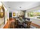 Elegant dining room with a glass-top table, designer chairs, and a large window at 1538 S Orange Ave, Sarasota, FL 34239