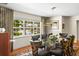 Formal dining room with a glass-top table, elegant chairs, and a large window overlooking the yard at 1538 S Orange Ave, Sarasota, FL 34239