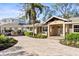 Attractive property featuring a well-maintained paver driveway, complemented by lush landscaping and an attached carport at 1538 S Orange Ave, Sarasota, FL 34239