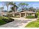 Inviting home with a paver driveway, complemented by lush landscaping, and a covered entrance at 1538 S Orange Ave, Sarasota, FL 34239