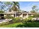 Charming single-story home with manicured landscaping, a lovely front lawn, and a paver driveway at 1538 S Orange Ave, Sarasota, FL 34239
