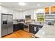 Well-appointed kitchen with stainless steel appliances, granite countertops and wood floors at 1538 S Orange Ave, Sarasota, FL 34239