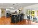 Open kitchen with bar seating, stainless steel appliances, and a sliding door to the outdoor patio at 1538 S Orange Ave, Sarasota, FL 34239