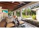 Inviting screened-in patio with comfortable seating and views of the lush backyard at 1538 S Orange Ave, Sarasota, FL 34239
