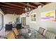 Covered porch includes dining table, chandelier, fan, and comfortable seating area for outdoor relaxation at 1538 S Orange Ave, Sarasota, FL 34239