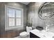 Stylish powder room with modern fixtures, decorative wall paper, and ample natural light from the window at 1538 S Orange Ave, Sarasota, FL 34239