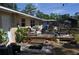 Backyard featuring a wood deck, chairs, and mature landscaping at 1711 30Th W St, Bradenton, FL 34205