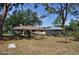 Fenced backyard with mature trees, a shed, and outdoor amenities at 1711 30Th W St, Bradenton, FL 34205
