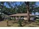 View of the backyard with a fenced perimeter, patio and lush, mature landscaping at 1711 30Th W St, Bradenton, FL 34205