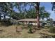 View of the backyard with a fenced perimeter, patio and mature landscaping on a sunny day at 1711 30Th W St, Bradenton, FL 34205