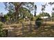 Large backyard with fencing, mature trees, a shed, and a play area at 1711 30Th W St, Bradenton, FL 34205