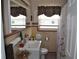 Functional bathroom featuring tile walls, a modern vanity, and a shower with a floral curtain at 1711 30Th W St, Bradenton, FL 34205