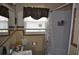 Bathroom featuring tile walls, a modern vanity, and a shower with a floral curtain at 1711 30Th W St, Bradenton, FL 34205