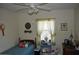 Comfortable bedroom showcasing twin bed, window with lace curtains, and ceiling fan with light fixture at 1711 30Th W St, Bradenton, FL 34205