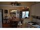 Cozy dining area adjacent to kitchen, featuring wood table, chandelier, and built in shelves at 1711 30Th W St, Bradenton, FL 34205