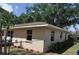 Beige home exterior, backyard perimeter fence, and landscape bed at 1711 30Th W St, Bradenton, FL 34205