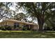 Lovely single-story home with a well-kept lawn, mature trees, and an attached garage at 1711 30Th W St, Bradenton, FL 34205