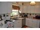 Well-lit kitchen featuring white cabinets, modern appliances, and a stainless steel sink at 1711 30Th W St, Bradenton, FL 34205