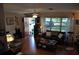 Spacious living room with a red door, a leather sofa, and a large window at 1711 30Th W St, Bradenton, FL 34205