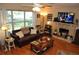 Inviting living room featuring a brick fireplace and a cozy leather sofa at 1711 30Th W St, Bradenton, FL 34205