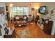 Bright living room with a fireplace, large window, and classic hardwood floors at 1711 30Th W St, Bradenton, FL 34205